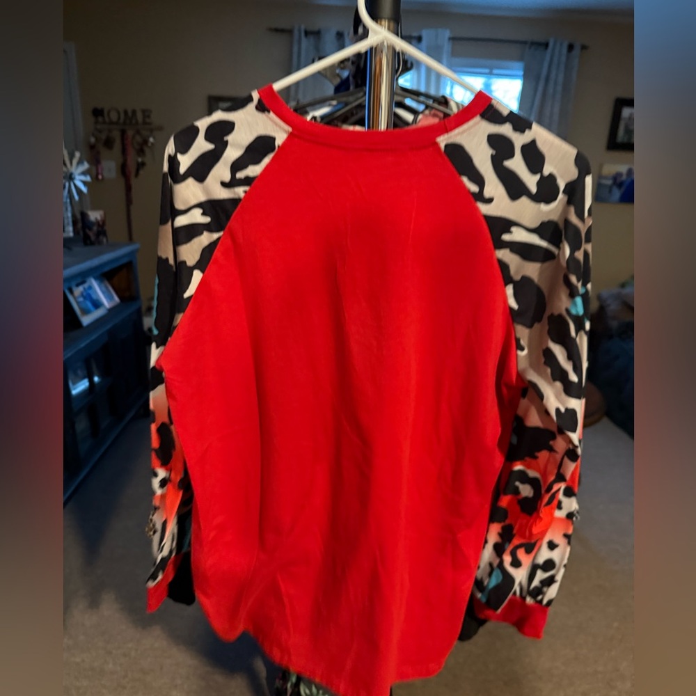 Red top with animal print sleeves